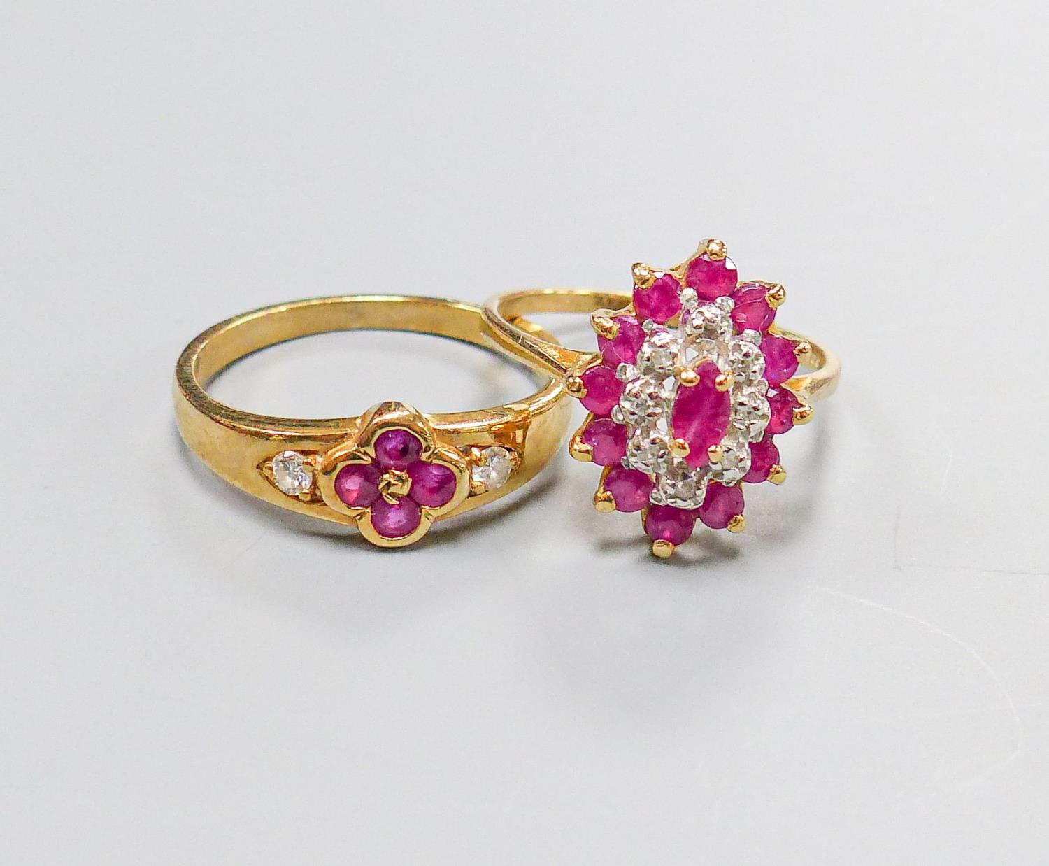 A 9ct yellow gold, ruby and diamond oval cluster ring, size M and another similar 9ct ring, gross