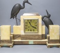 An Art Deco marble clock garniture clock surmounted with two spelter cranes,42cm