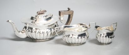 An Edwardian demi-fluted silver three piece bachelor's tea set, Chester, 1909, gross 15.5 oz.