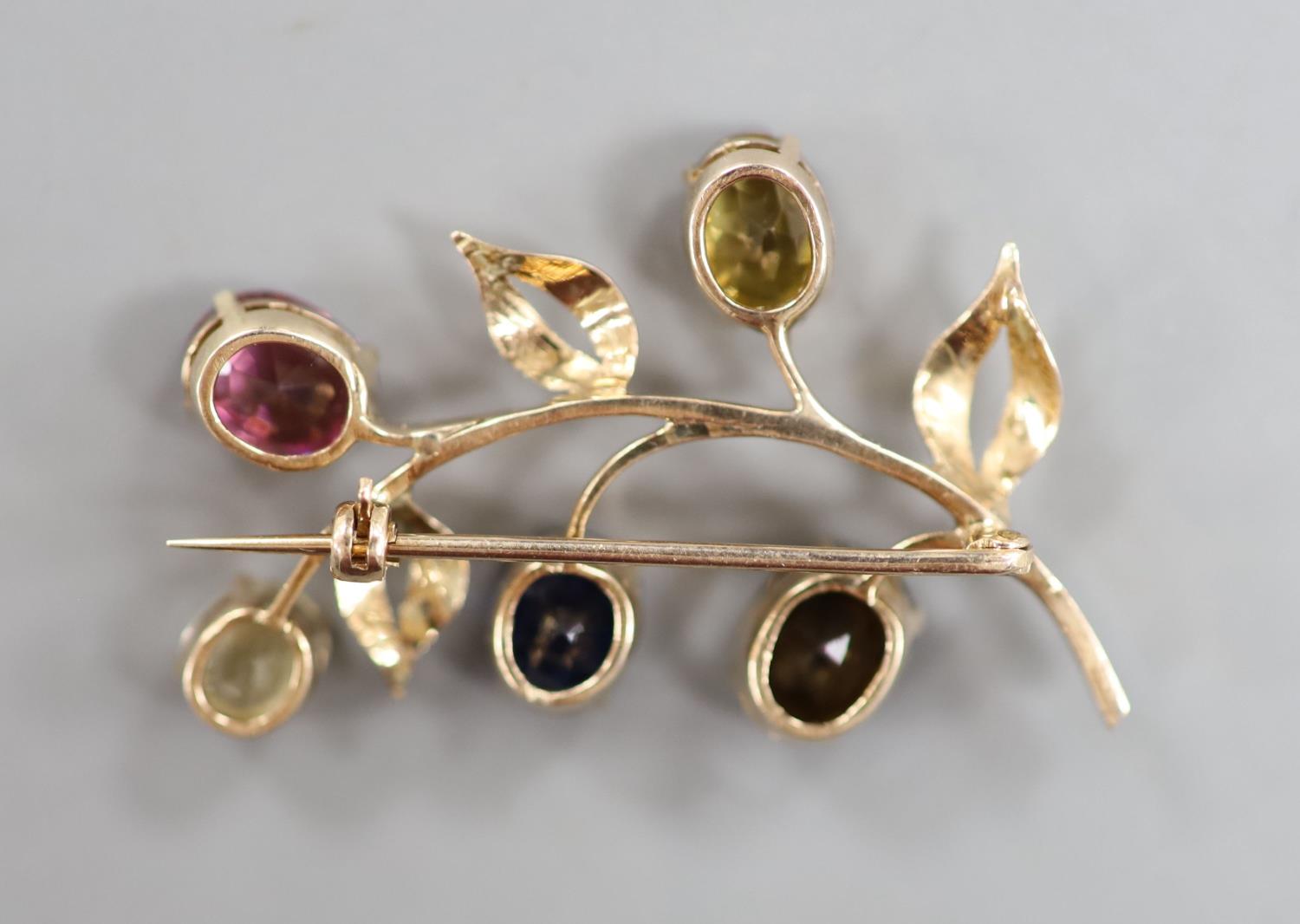 A yellow metal and multi gem set (including sapphire, tourmaline and garnet) floral spray brooch, - Image 2 of 2