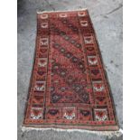 A Turkish red ground rug, 212 x 106cm