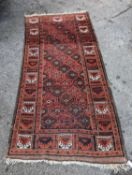 A Turkish red ground rug, 212 x 106cm