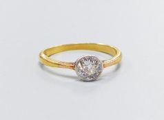 An 18ct and collet set solitaire diamond ring, size M, gross weight 2.3 grams,the stone weighing