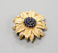 A 1960's 18ct gold, sapphire and diamond cluster set flower head brooch, 35mm.
