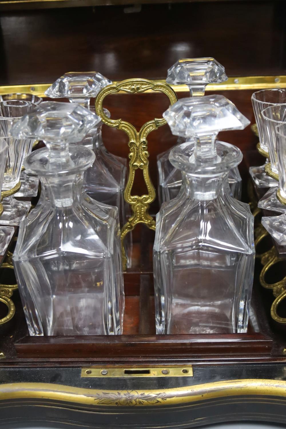 A mid-19th century French ebonised and brass-inlaid decanter case, fitted four decanters and seven - Image 3 of 4