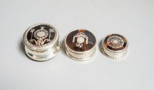 Three assorted early 20th century small silver and tortoiseshell pique circular boxes and covers,