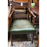 A pair of George III mahogany Sheraton style elbow chairs