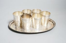 A set of six Chinese white metal tots by Tack Hing, 50mm and a small oval tray by Kingsburg, Hong
