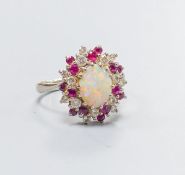 An 18ct white metal, white opal, ruby and diamond set oval cluster ring, size N, gross weight 6.1