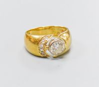 A modern 750 yellow metal and single stone diamond ring, with diamond set open work setting, size M,