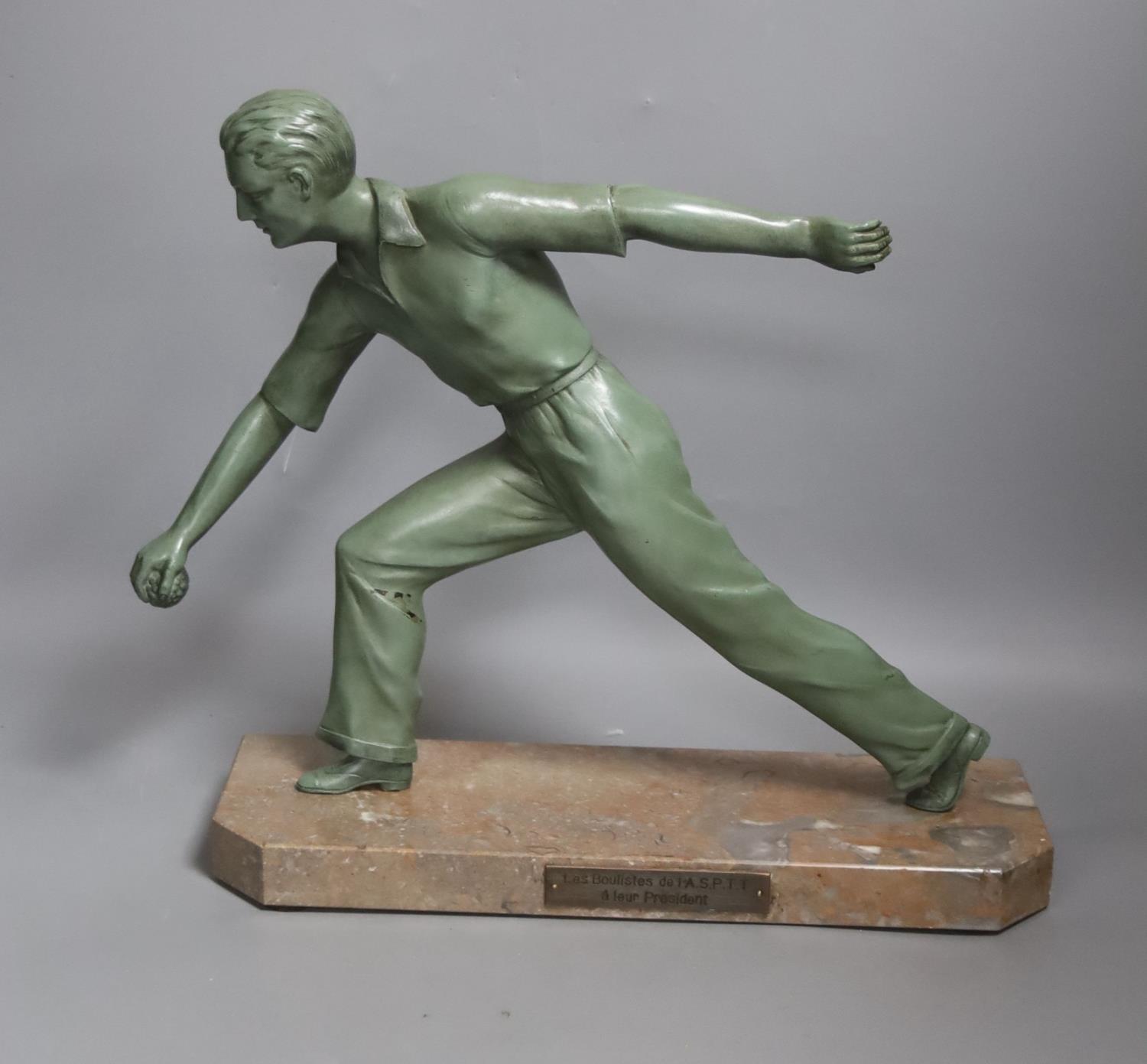 An Art Deco model of a gentleman playing boules. Marble base with plaque reading ‘Les boulistes de