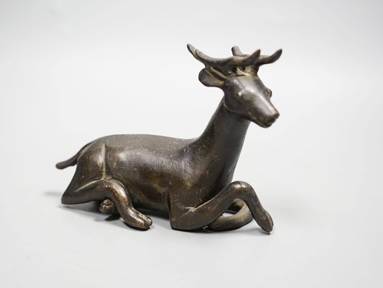 A Chinese early bronze figure of a deer, probably Yuan to Ming period, 13.5cm