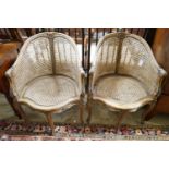 A pair of early 20th century French caned, carved beech Bergere chairs