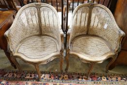A pair of early 20th century French caned, carved beech Bergere chairs