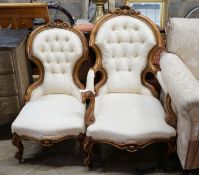 A pair of Victorian carved walnut chairs, one with arms
