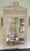 A late 19th century French blue and white painted gesso wall mirror, with laurel and floral basket