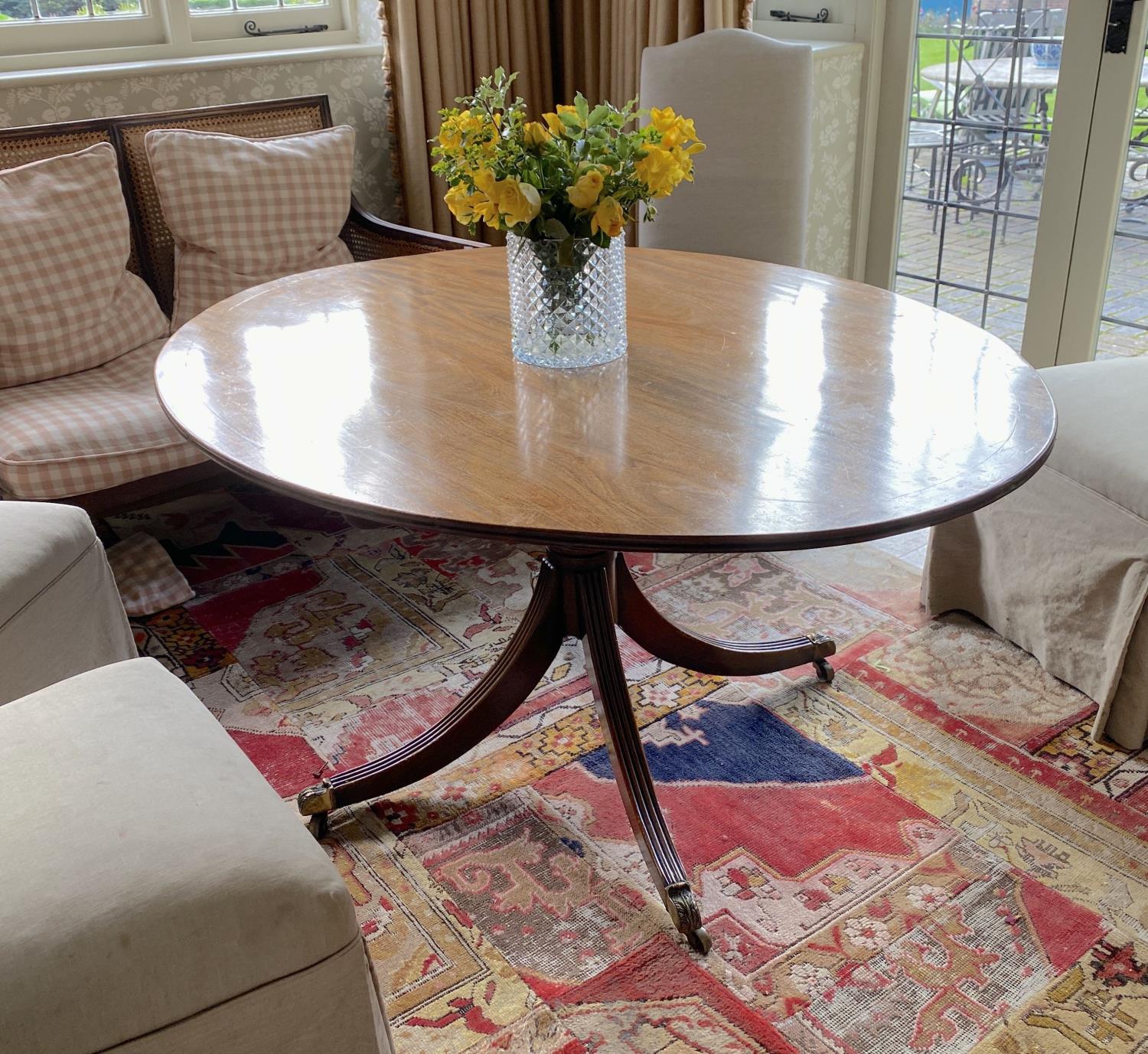 A Regency style mahogany breakfast table, with oval top on reeded downswept legs, width 150cm