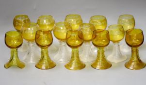 Fourteen German amber flashed roemers, nine wheel engraved with vines