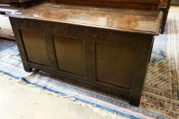 A late 17th / early 18th century carved and panelled oak coffer, length 136cm, depth 58cm, height
