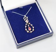 A modern 1920's style white metal, ruby and diamond set openwork oval drop pendant necklace, pendant