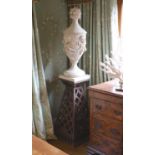 A pair of white painted carved walnut urns and covers, on wrought iron stands, the urns carved
