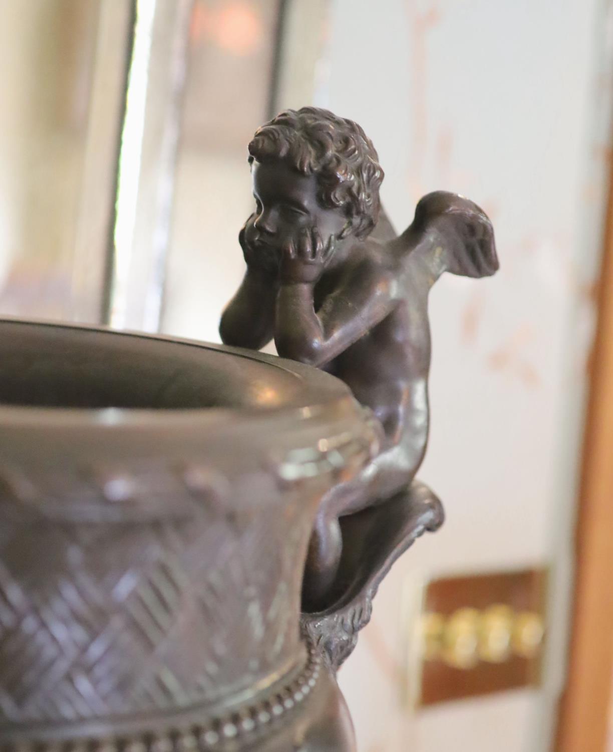 A classical style bronze urn modelled with disconsulate cherubs, height 44cm width 40cm - Image 3 of 4