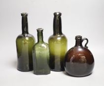 Two English dark green glass wine bottles, late 18th century, a Victorian amber glass hock jug and