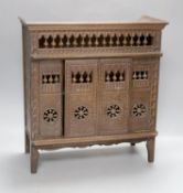 A 19th century French miniature carved oak cupboard with sliding doors. 37cm