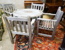 A set of four teak garden chairs and a circular parasol table, diameter 91cm chairs width 60cm