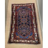 A Caucasian blue ground rug, triple bordered, 157 x 97cm