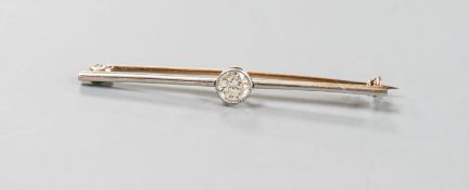 An early 20th century yellow metal and solitaire diamond set bar brooch, 57mm, gross weight 4.3