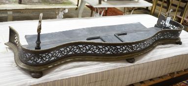 A Victorian brass and steel serpentine fender, length 142cm, depth 50cm