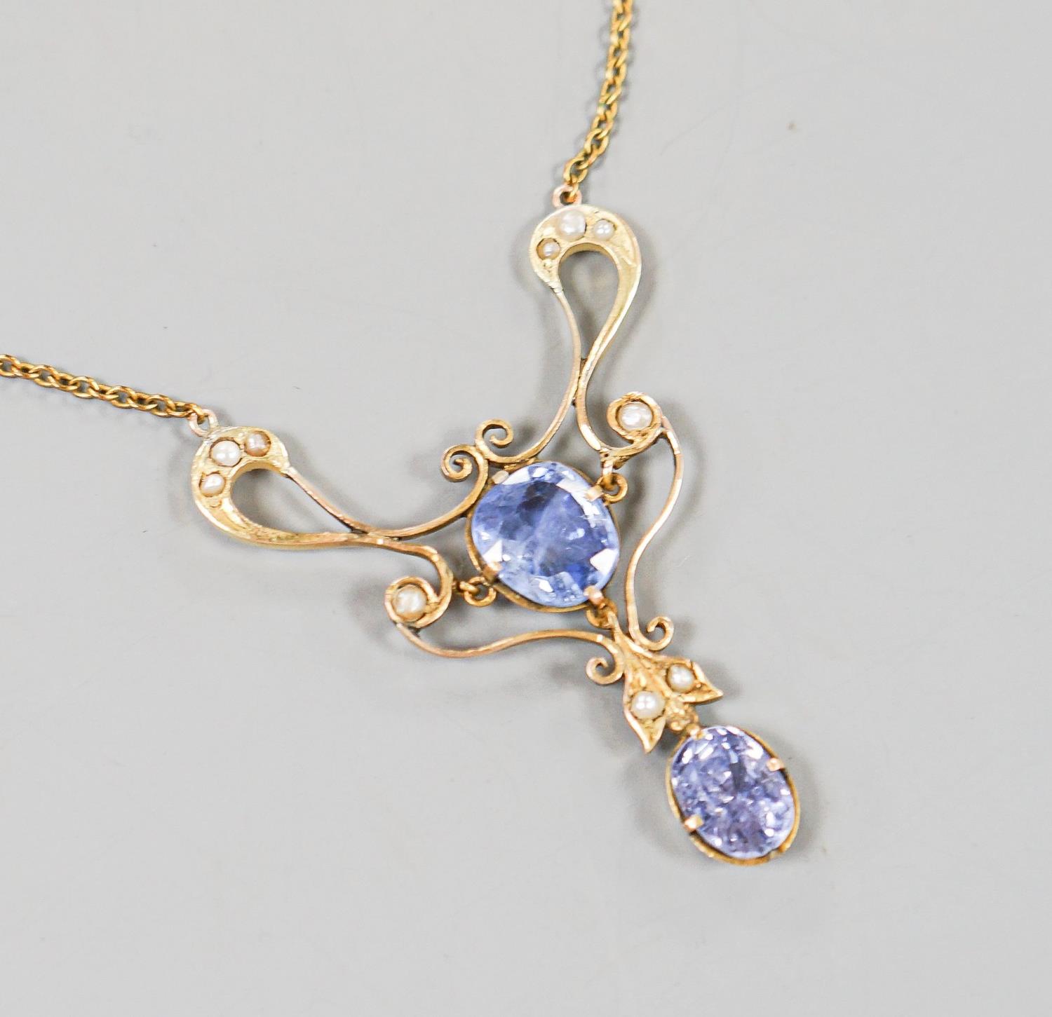 An early 20th century 9ct, two stone Ceylon sapphire and multi seed pearl set pendant necklace,