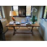 A Spanish style crossbanded walnut centre table, with floral carved border and gilt metal mounted