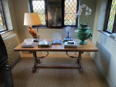 A Spanish style crossbanded walnut centre table, with floral carved border and gilt metal mounted