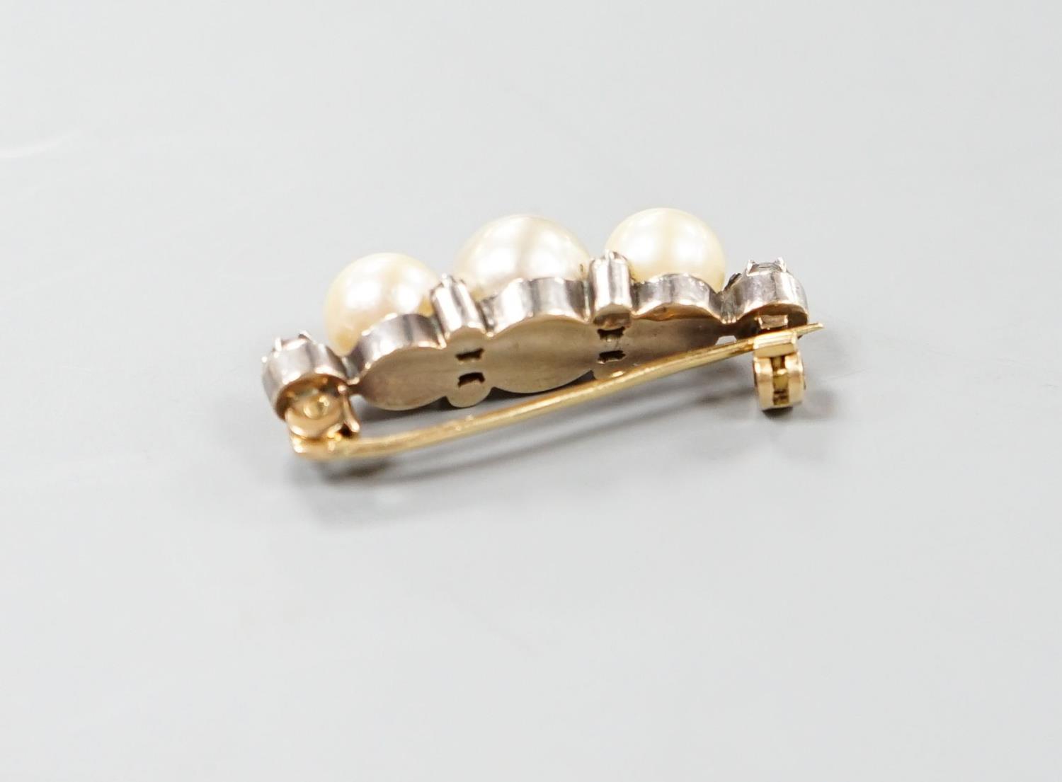 A yellow metal, three stone cultured pearl and six stone diamond brooch, 34mm, gross weight 8.1 - Image 2 of 4
