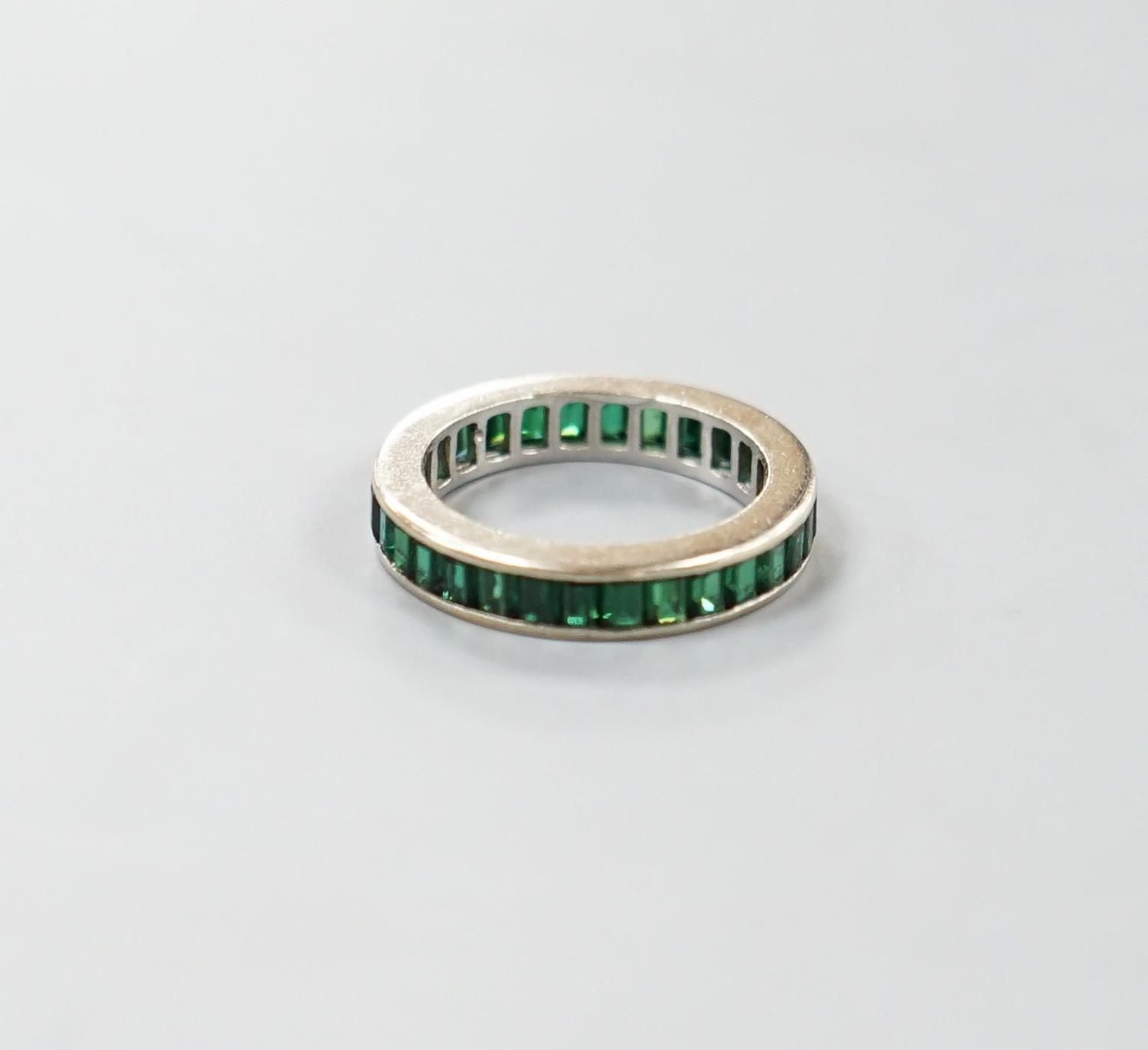 A white metal and green garnet? set full eternity ring, size L, gross weight 3.3 grams. - Image 2 of 3