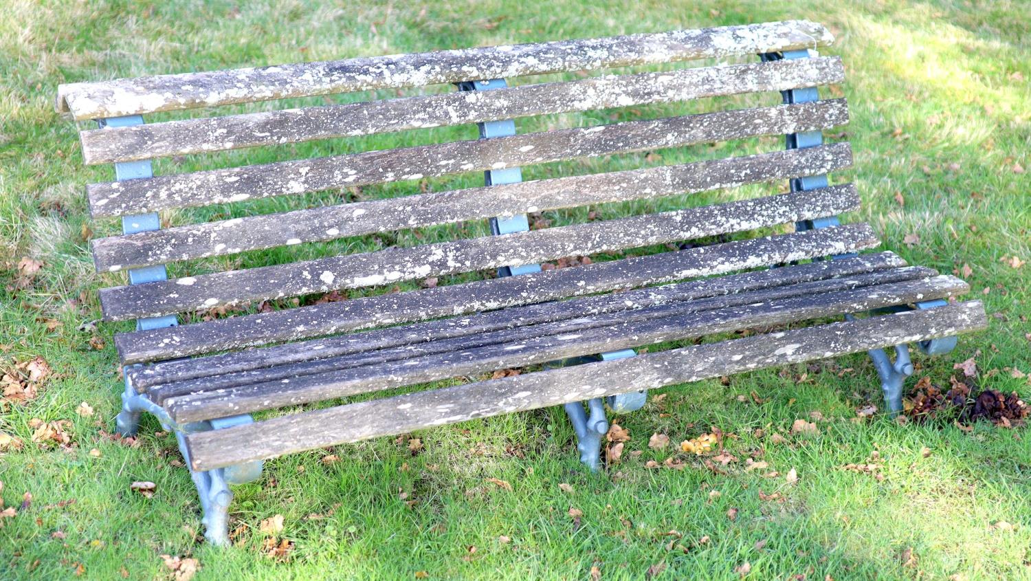 A pair of Coalbrookdale style cast iron and slatted teak garden benches, width 165cm depth 77cm