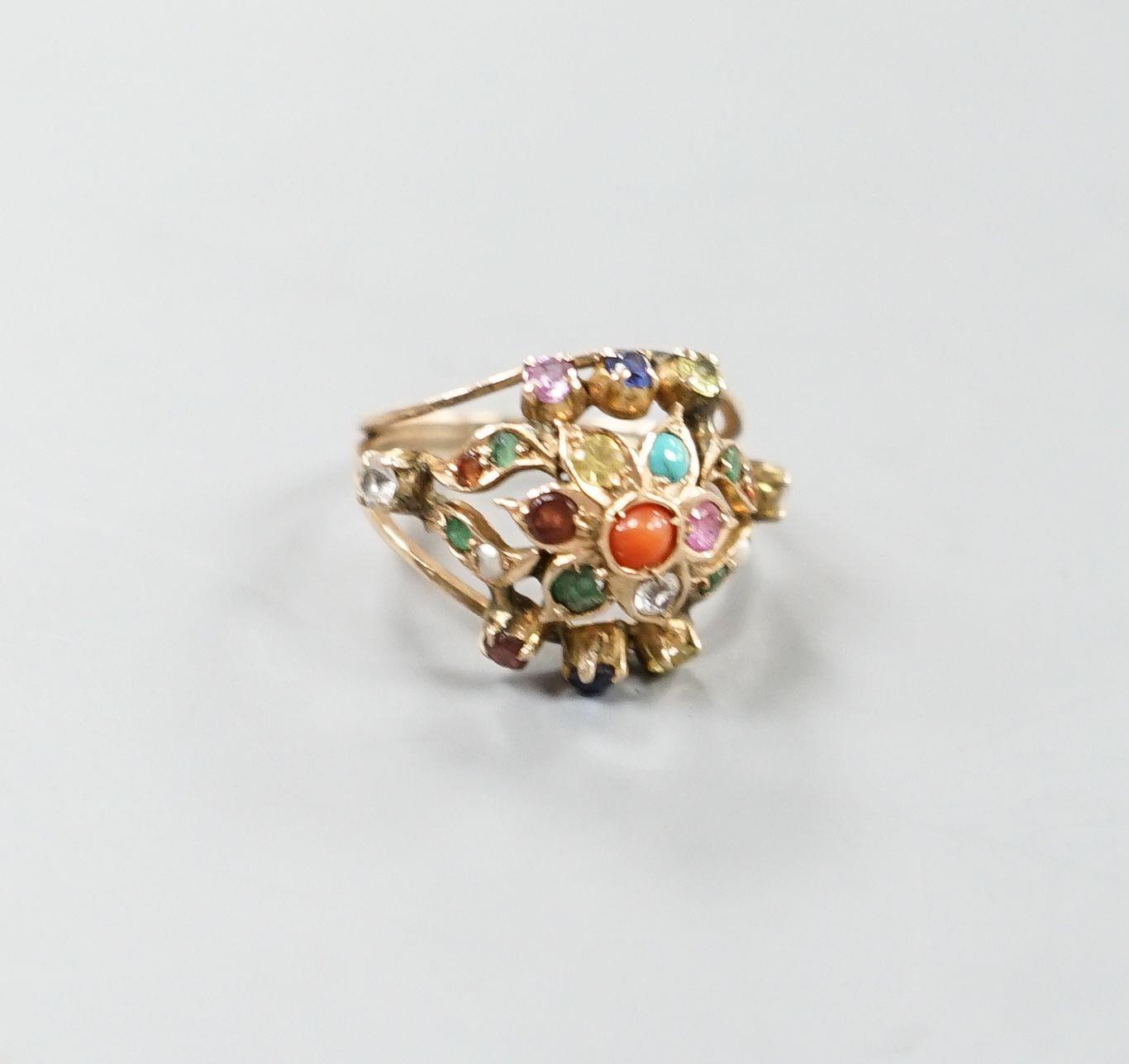 An early 20th century Arts & Crafts yellow metal and multi gem set set cluster ring, size H/I, gross