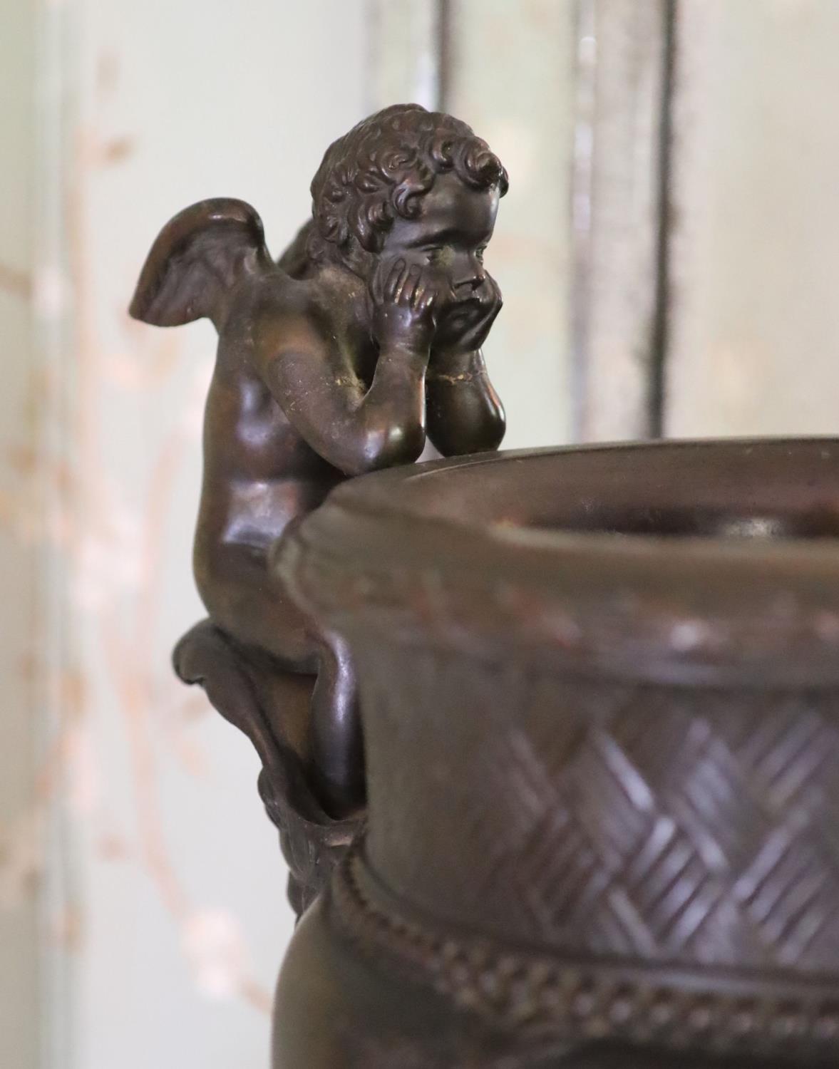 A classical style bronze urn modelled with disconsulate cherubs, height 44cm width 40cm - Image 2 of 4