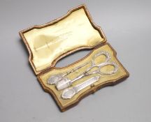 A cased 19th century French white metal necessaire, containing, scissors, needle case thimble etc,