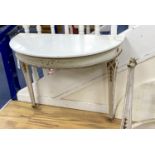 A pair of French marble topped demi lune console tables, with later veined white marble tops and