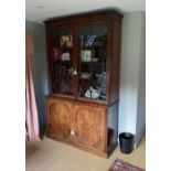 A George III mahogany bookcase, with two astragal glazed doors enclosing adjustable shelves over two