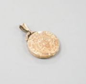 An Edwardian engraved 9ct gold circular locket, 23mm, gross weight 4.4 grams.