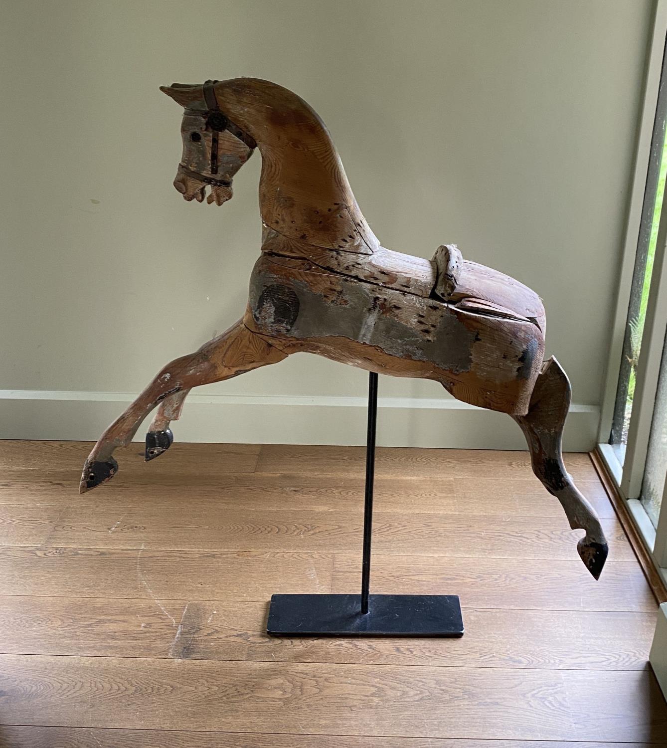 A Victorian painted pine rocking horse, now on wrought iron stand, length 96cm height including