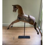 A Victorian painted pine rocking horse, now on wrought iron stand, length 96cm height including