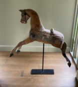 A Victorian painted pine rocking horse, now on wrought iron stand, length 96cm height including