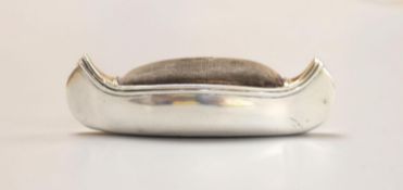 An Edwardian silver mounted pin cushion, modelled as a canoe, Cohen & Charles, Birmingham, 1906.