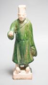 A Chinese Ming green glazed figure of an official 23cm