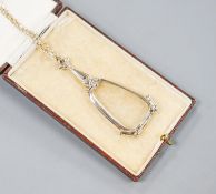 A modern 14k white mounted lorgnettes, 62mm, gross 14.1 grams, on a modern 750 white metal chain,